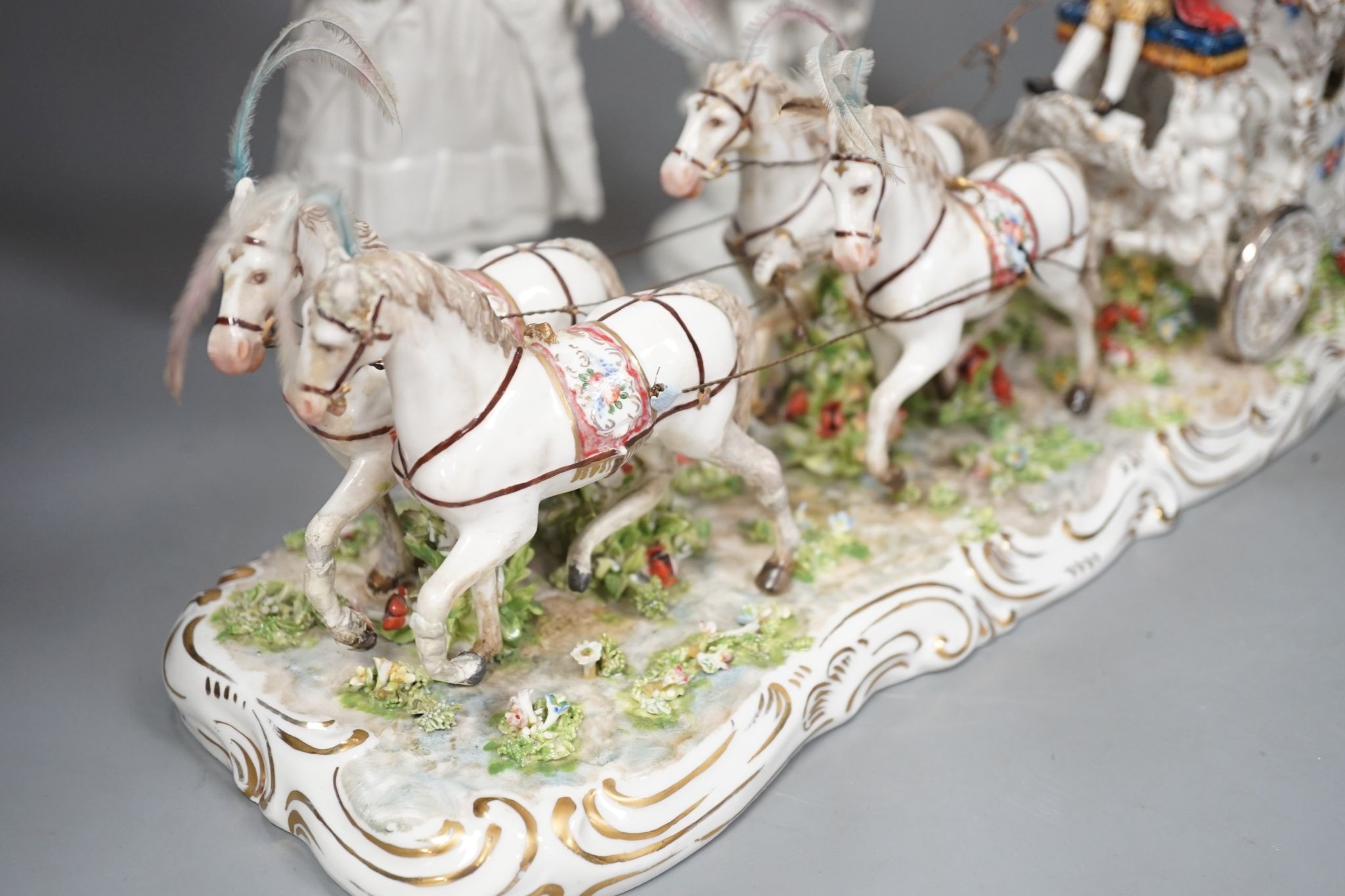 A large Italian porcelain carriage group and a pair of Italian white porcelain figure of a lady and a man 54cm